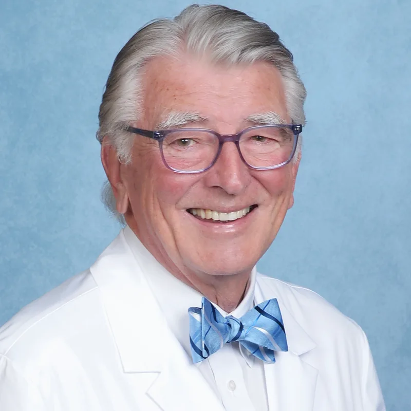 George W. Carroll, MD, in a white medical coat