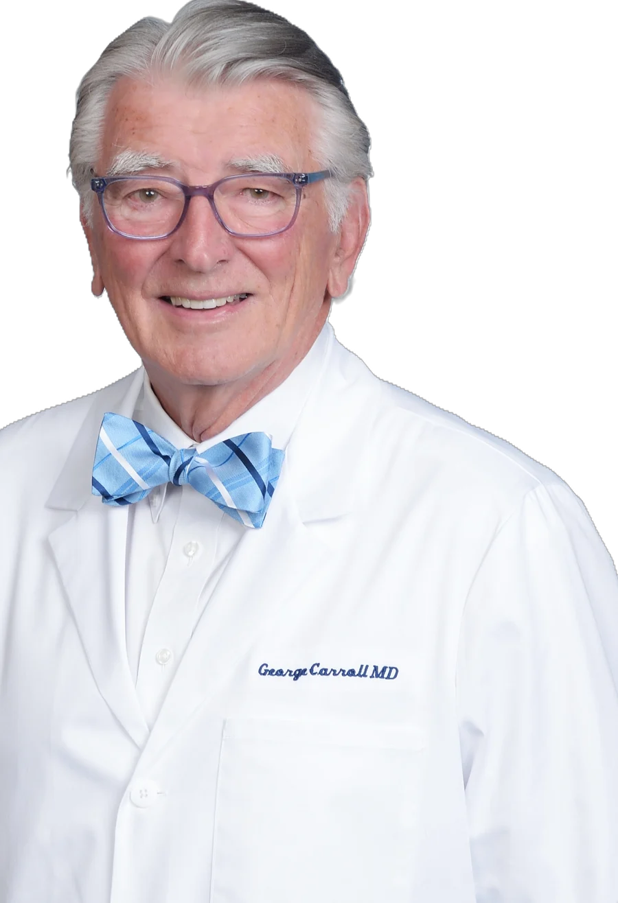 George W. Carroll, MD, in a white medical coat and bow tie