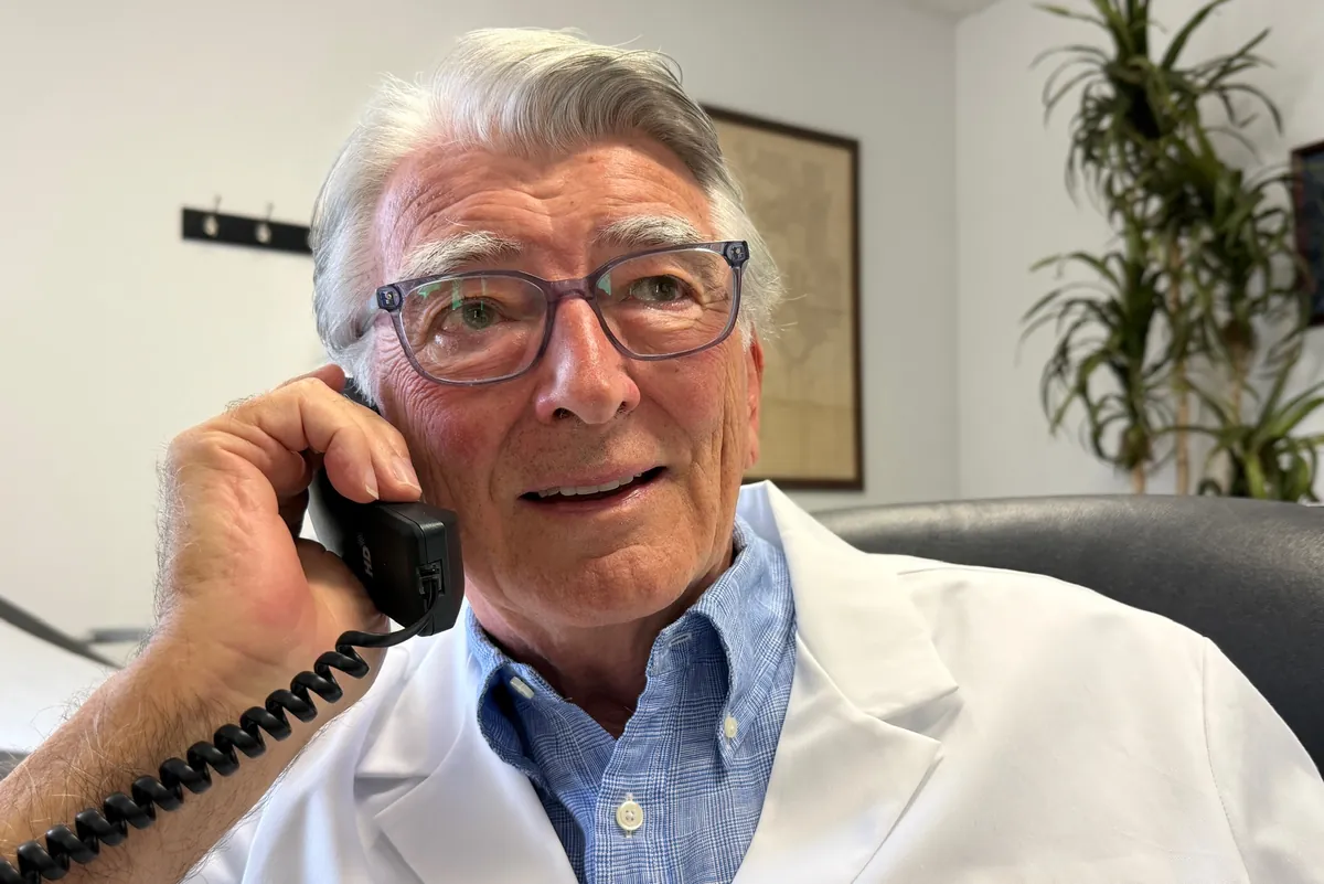 Dr. Carroll on the office phone at his desk