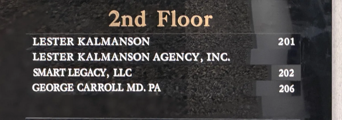 The building's second-floor directory, listing George Carroll MD, PA in Suite 206